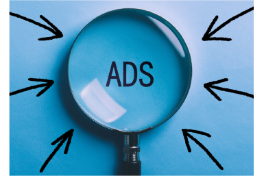 Magnifying glass focusing on the word ADS, representing Google Ads and paid online advertising strategy